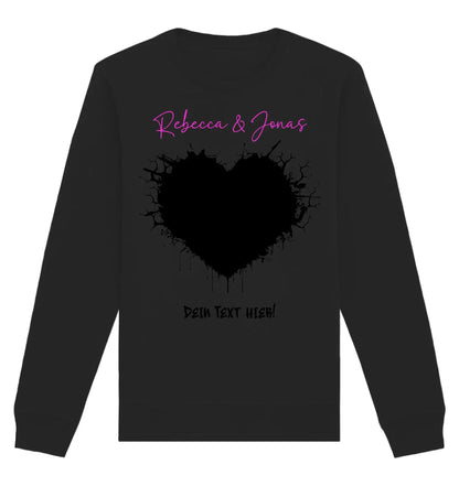Schwarzes langärmeliges shirt aus der statement-collection mit pinkem rebecca und jonas schriftzug über herzgrafik